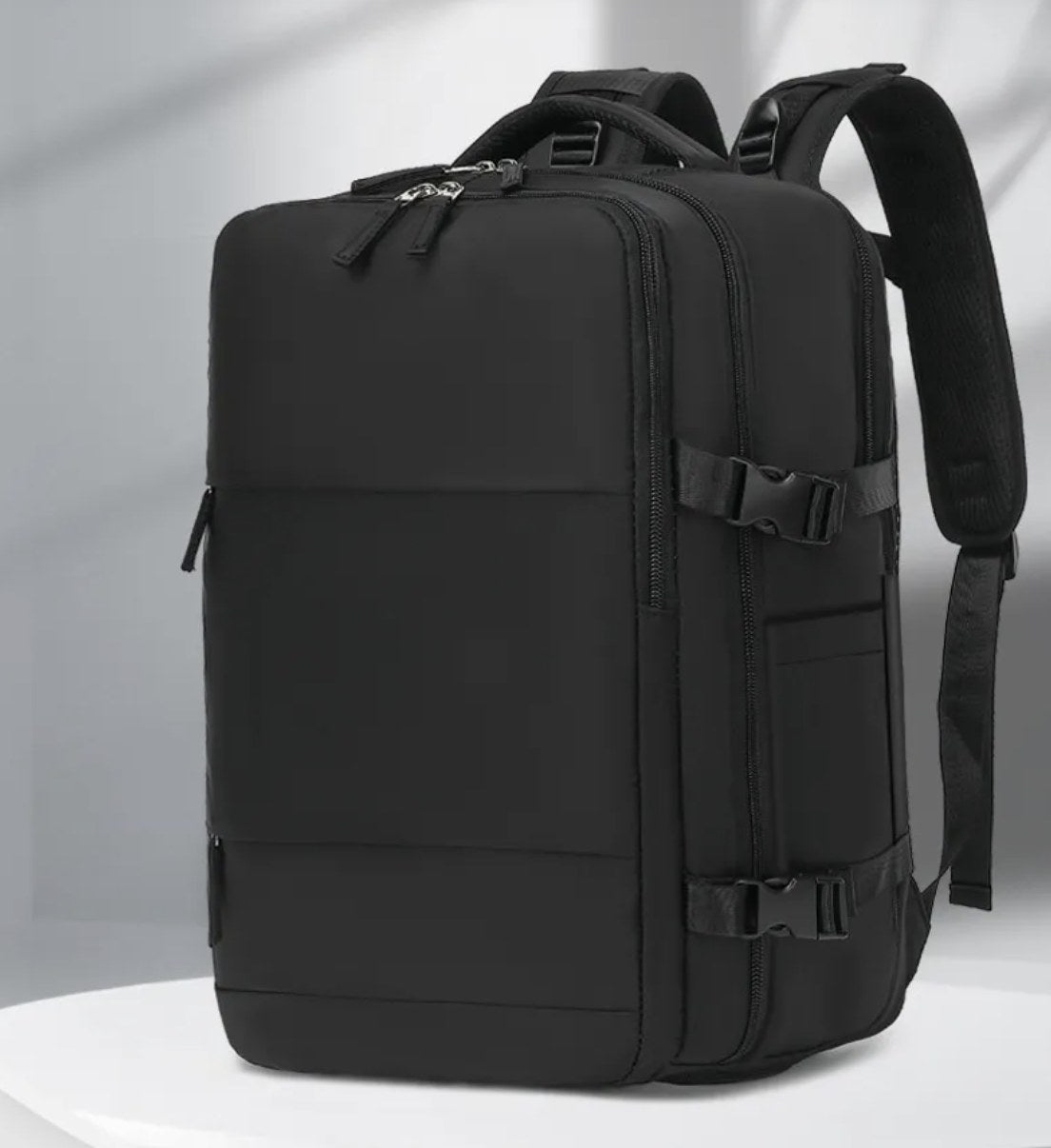 Voyat AirPack in black, three-quarter view with the main compartment expanded